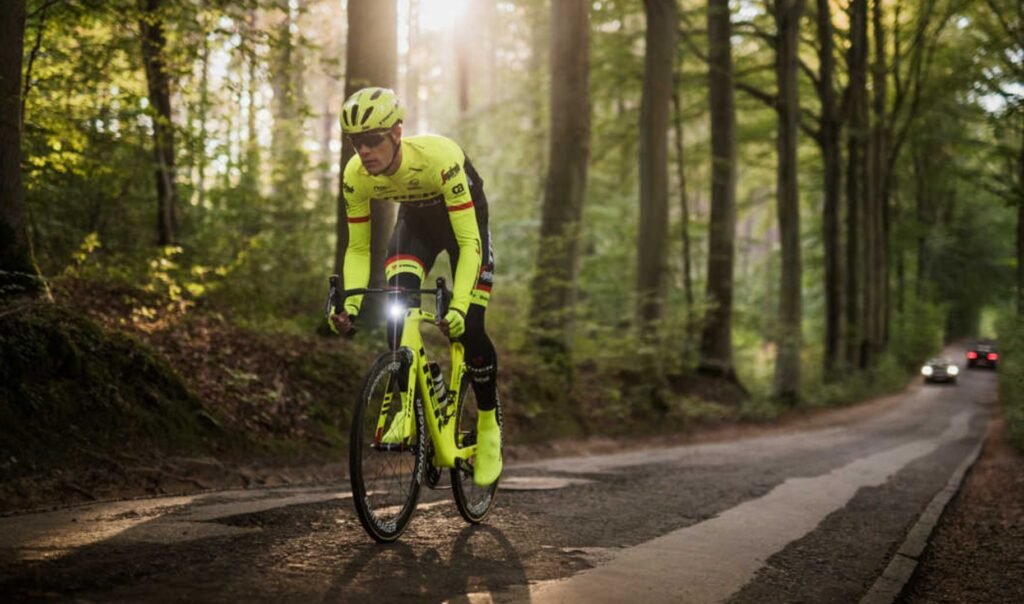 Cyclist staying safe during a long-distance ride with reflective clothing and a helmet.