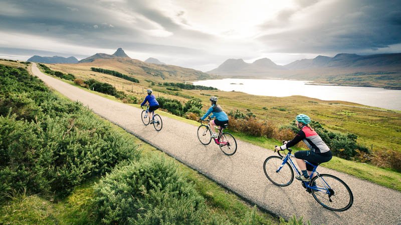 Cyclist enjoying coastal views on the North Sea Cycle Route from Norway to Scotland